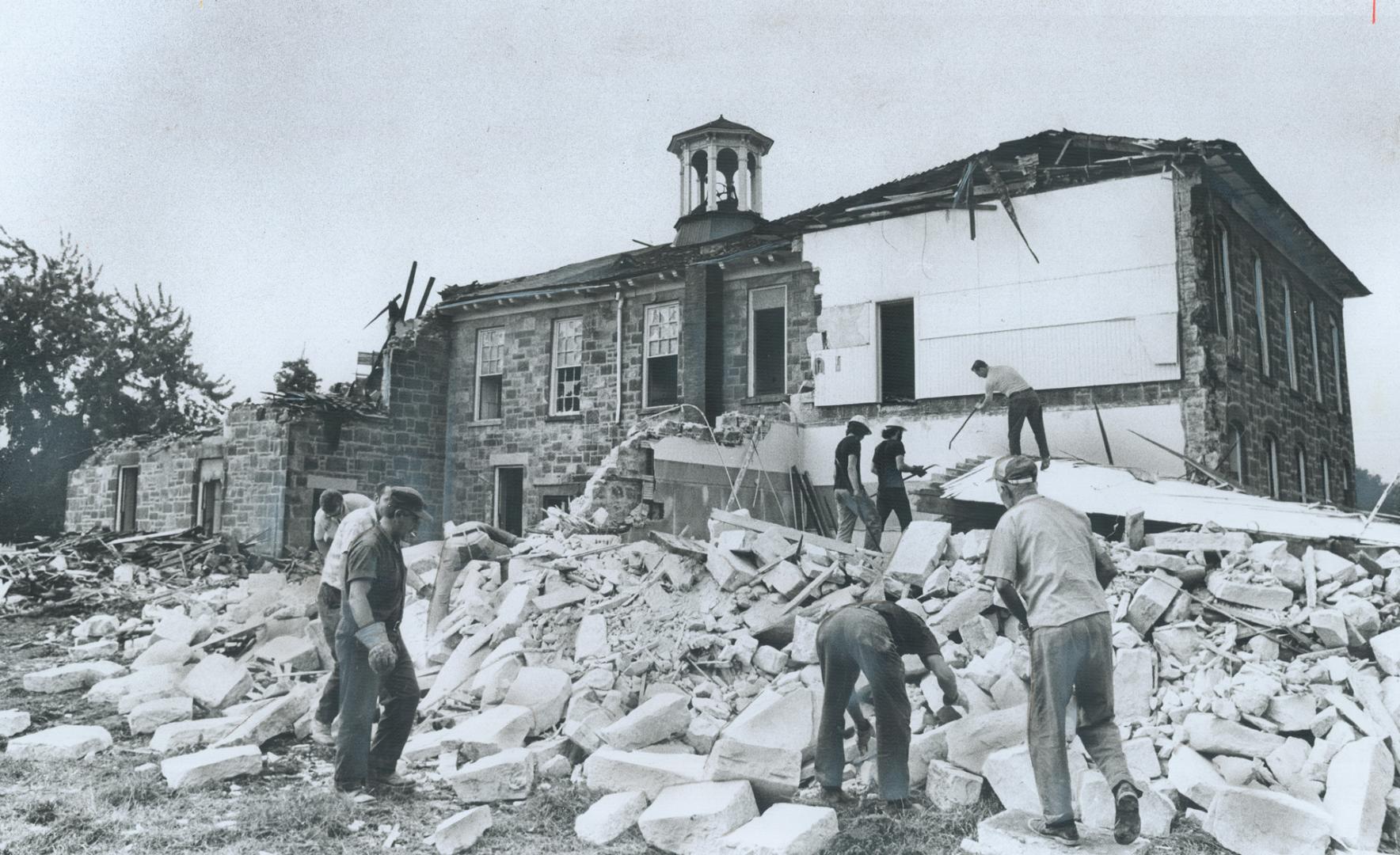 The 115-year-old Bruce Street School in Milton, the oldest building in use as a symbol in Halton County, falls to the wrecker's hammer making way for (...)