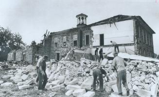 The 115-year-old Bruce Street School in Milton, the oldest building in use as a symbol in Halton County, falls to the wrecker's hammer making way for (...)
