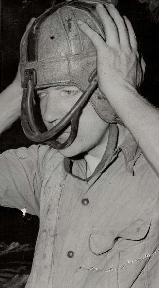 That helmet which Red Hill used in his trips, saved his head from a terrific beating as he was tossed about