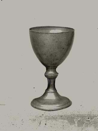 Gray chalice with some dark flecks and discolouration. 