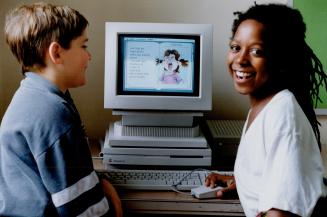 Real Picture Book: Corbin Reaney-Barker, left, and Simba Spear, both 9, enjoy electronic reading from a Discis disc through the computer at Claude Watson School for the Arts in Toronto