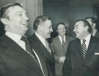 Prime Minister Pierre Trudeau (right) listens to a question at the news conference at which he announced his cabinet changes. Three ministers happy wi(...)
