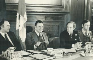 Finance Minister Donald Macdonald, Privy Council President Allan MacEachen and Prime Minister Pierre Trudeau sit together in library of Royal York Hot(...)