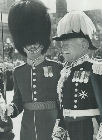 In resplendent uniform of a civilian governor-general, Roland Michener passes the chief of his guard of honor, leaving Houses of Parliment after deliv(...)