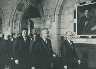 Back to work on Parliament Hill goes opposition leader Diefenbaker-and Mackenzie King looks down approvingly