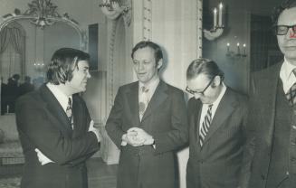 A newcomer to the cabinet, Postmaster-General Andre Ouellet (left a lawyer from Montreal-Papineau, talks with Jean Chretien (centre), minister of Indi(...)
