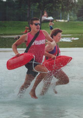 Duelling Lifeguards. Head lifeguard Kim Gray (right) and colleague Steve King make a splash at Petticoat Creek Coservation Area. Armed with torpedo li(...)