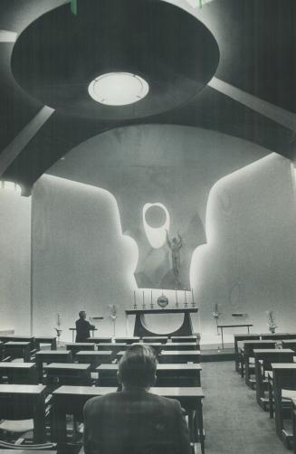 Worshippers meditate in chapel which is of space-age design