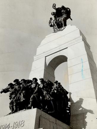 Bronze Brigade- Up tips the camera to get an effective angle-shot of Canada's new war memorial at Ottawa, the sun glinting on its impressive figures