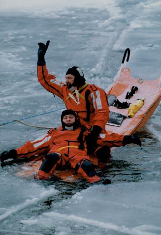 Firemen to the rescue. Firefighters Jim Donald, lying in the water on his back, and Dave MacEacheran, both from number 4 station in Port Credit, take (...)