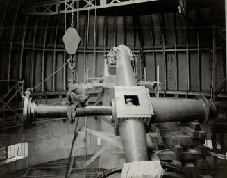(2) A view of the interior of the dome of the Dunlap Memorial, showing the massive polar axis of the telescope