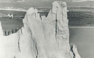Rescue squad on bluff (left) backs up fireman Rick Turner (top, middle) as he starts descent to Wayne Eastman (lower right and inset)