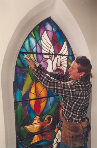 A luminous beauty. Ted Schneider puts final touches on one of two stained glass windows at St. Andrew's Presbyterian Church in Scarborough. The window(...)