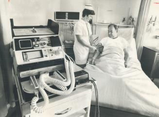 Electronic equipment in Scarborough Centenary Hospital helps Diane Ellis, seniro leader of the coronary nursing team, check on patient Stephen Jessome(...)