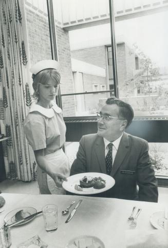Principal Howard L. Eubank has his dinner served in staff dining room by students waitress Denise Pogue, 15. The young cooks prepare gourmet dishes li(...)