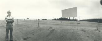 Francis Ward, manager of the Seven and Twenty-Seven Twin Drive-in, stands in a huge, valuable expanse of parking lot