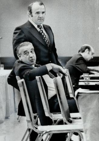 The surgeon who had the oxygen lines checked in Sudbury General Hospital, Dr. Francis Power, stands behind lawyer Elmer Sopha at the inquest into 23 deaths