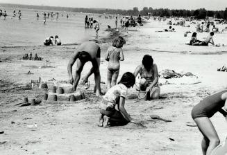 Family fun: There are still tiny bikinis on Wasaga Beach but they have competed for space with families buiding sand-castles since the province took over the beach