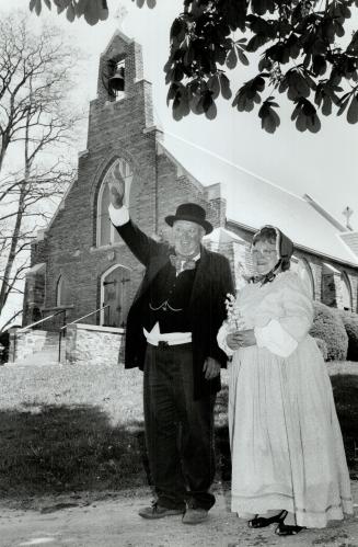Days of Yore: Jack and Laurie Marynard wear the clothes of the times in front of historic Christ Church, which is marking 150 years of Anglican worship