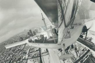 A Falcon's-eye view of Toronto, A wing-mounted camera captures this view of the Toronto skyline with pilot Larry Newman, 37 (left), and Star photograp(...)