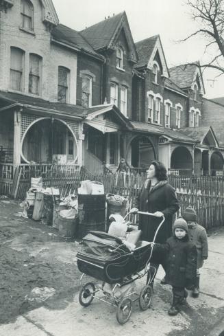 Along Crumbling St. James Street - where the shadow of 200 evictions hangs-Mrs. Alberta Manduck goes house-hunting with her neighbor's children