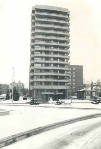 Hillhurst tower, a 14-storey brick and concrete apartment condominium building, dominates the corner of Bathurst St