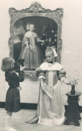 Sorcha O'Carrol, 9, submits to having her picture taken by Laura Martin, 8, while she is dressed up as the girl in Jan Rootius' Portrait Of A Young Gi(...)