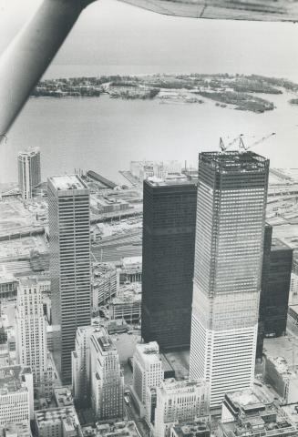 The Last Girder is raised 951 feet to the top of the 72-storey First Canadian Place, built by the Bank of Montreal, on King St. W. yesterday the only (...)