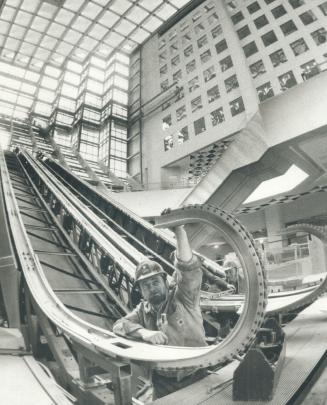 Royal Bank plaza nears completion, One of 12 escalators being installed in Royal Bank Plaza is checked by workman Tom Hanna in main concourse of compl(...)