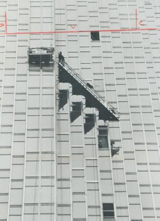 Glazier Steve Kelly lowers scaffold down Royal Bank's sheer glass face