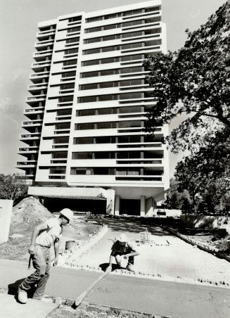 Workmen are busy putting the finishing touches on 150 Heath Street West, a new 14-storey luxury condominium apartment building at Heath St. W. and Avenue Rd., just south of Upper Canada College