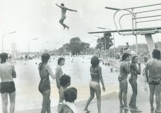 He's leaping for joy into refreshing blue water at Sunnyside Park pool yesterday, and who'd blame him? Fernando Sousa, sporting maple leafs on his swi(...)