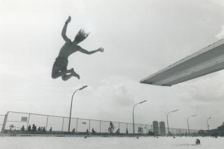Do it again soon, Sun, Sunshine's been so rare this summer, this youth was putting a lot of pent-up energy into his flying leap yesterday at Toronto's(...)