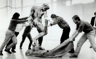Workers at the Art Gallery of Ontario manoeuvre Rodin's 450-kilogram (1,000-pound) sculpture Adam into place for a new exhibit. The show at the Dundas St. gallery opens Jan. 24