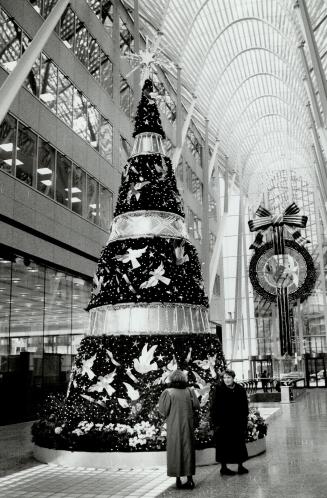 Concerted effort. The giant Christmas tree at BCE Place, Yonge and Front Sts., is the focus for a variety of performers and groups entertaining lunch-(...)