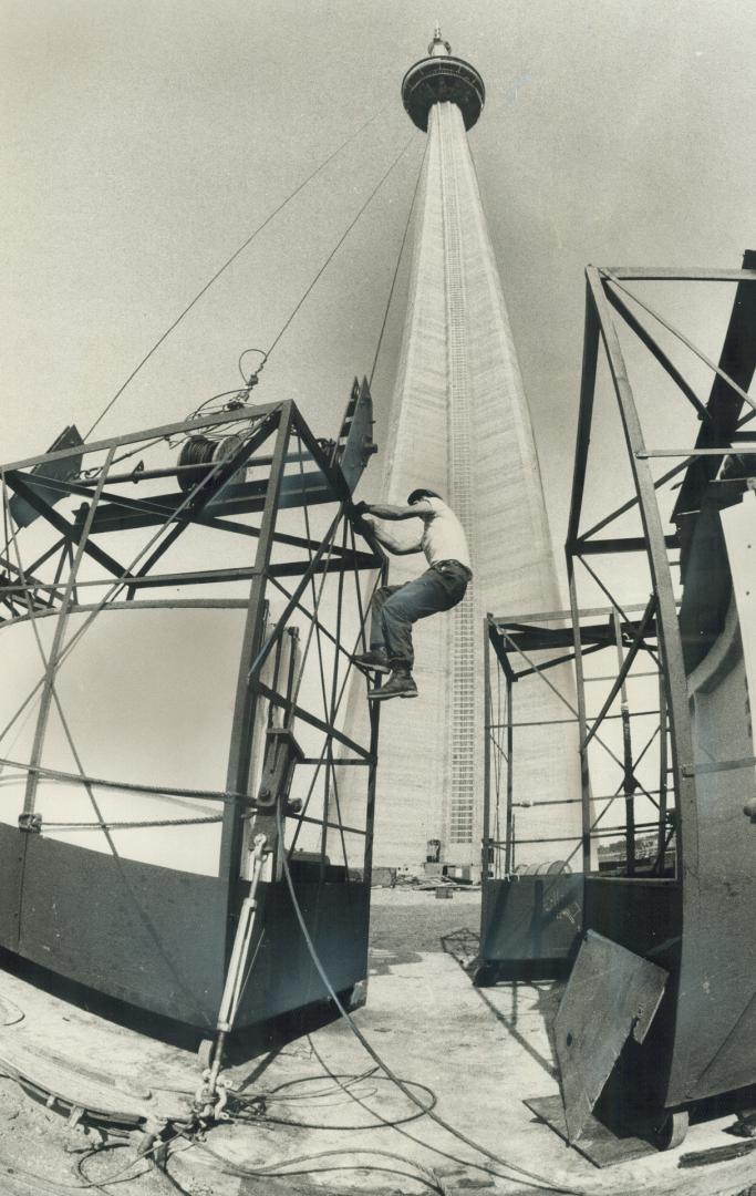 Protective coat for CN tower. All-weather coating to protect the CN tower's mast from ice and snow is being installed. First sections of the fiberglas(...)