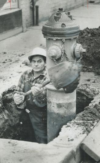 Putting his back into it, Arthur Albright wields a shovel to remove hydrant at Yonge St