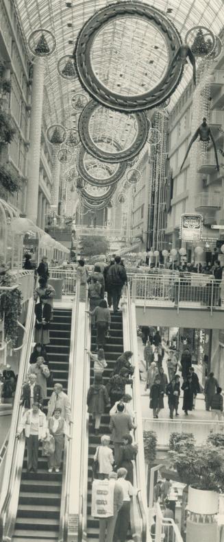 Early shoppers: The Eaton Centre is dressed in its Christmas garb waiting for the siege - but will it come? Some analysts believe that, despite the market blues, sales will be buoyant