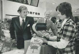 Newest in cash registers is checked by John Craig Eaton, left, at opening of new T