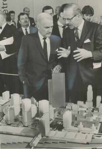 Model of Metro Centre development proposed for downtown Toronto is surveyed yesterday by Mayor William Dennison (right) and Canadian Pacific Railway c(...)