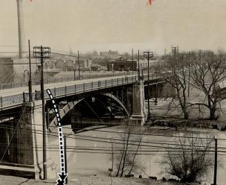Dropped from the Dundas St. E. bridge, the body of a two-day-old baby in a paper bag was found on the banks of the Don river by two boys