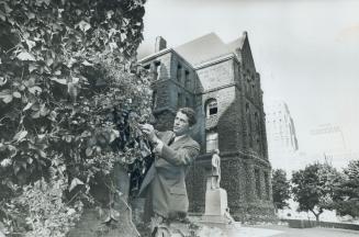 Examining ivy on the walls of Queen's Park, Public Works Minister James Auld says it will have to be cut down this fall so the 83-year-old building can be cleaned