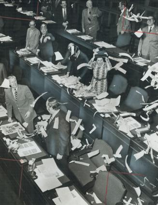 Government members of the Legislature cheer at the close of longest single session in memory, a 17 1/2-hour sitting that ended at 10.03 this morning. (...)