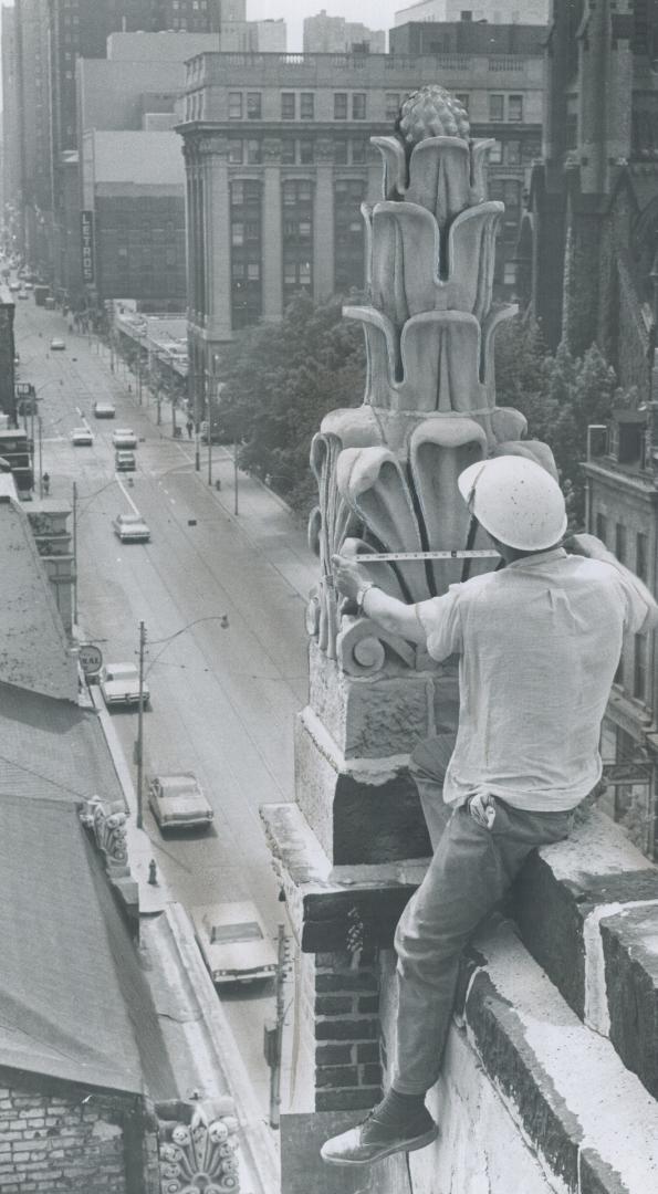 Workman measures Ornamental Piece of Stonework, Restoring St