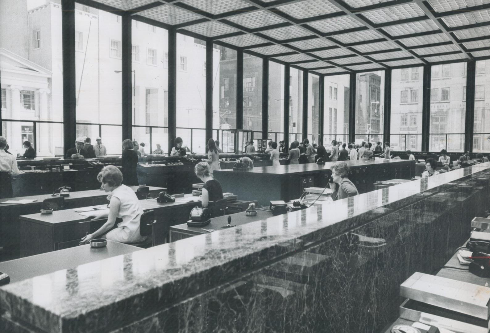 Ultramodern banking pavilion in the Toronto-Dominion Centre has a plush carpeted interior behind tinted glass walls