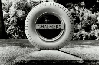 Image shows a tombstone-tire that reads: CHALMERS.