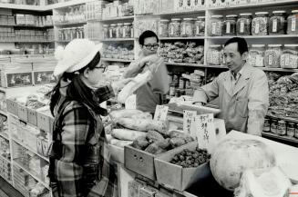 Mrs. Monica Wong comes all the way from Kitchener to shop in this store in Toronto's Chinatown. Here she chooses a large, white radish for one of her (...)