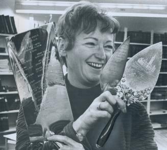 Mementoes of city halls past and present are held by Shirley Brown, of the city's Records Department