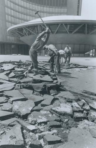 They're fixing a roof, Workmen rip up asphalt on podium roof of City Hall as the long search continues for the leaks in the roof above the office of Controller Margaret Campbell's secretary