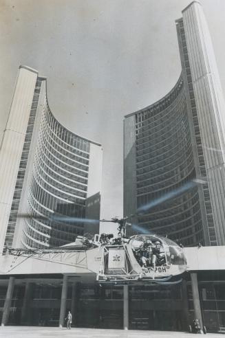 Candid camera on Copter, While helicopter hovers only five feet above Nathan Phillips Square, cameraman Jeep Boyko films the Toronto scene